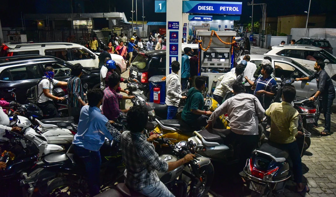 Motorists wait to refuel at a crowded Hyderabad filling station.