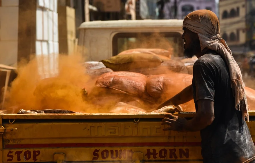 A worker packs flour bags at a wholesale market in Hyderabad.
