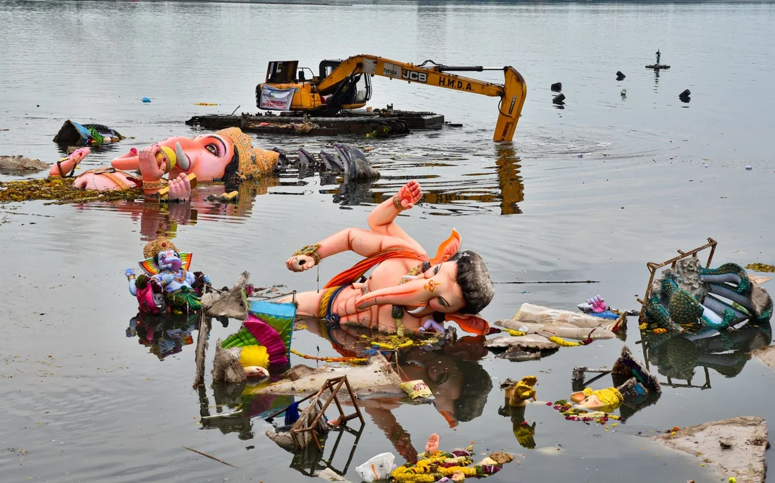 An amphibious excavator clears the remains of immersed Ganesh idols from Hussain Sagar.